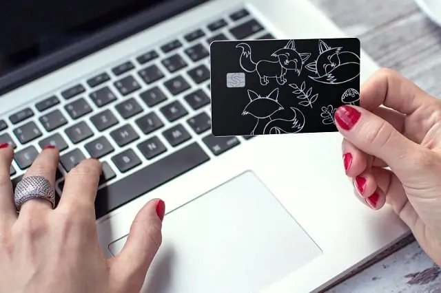person holding cash card cat design